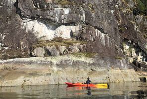 canada british columbia kayaker looking at pictoglyphs kwr