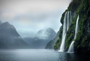 new zealand doubtful sound waterfalls cloudy day istk