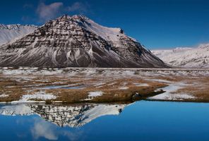 north iceland siglufjordur snow topped mountain reflection istk 1