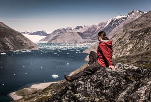 south greenland hiker overlooking qooroq ice fjord near narsarsuaq vg