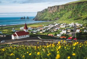 south iceland vik church and reynisdrangar sea stacks sunny day istk