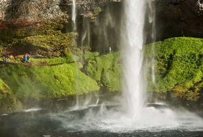 south west iceland people walking behind seljalandsfoss rth