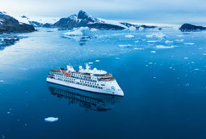 Aerial view of The Greg Mortimer expedition ship sailing in Antarctica