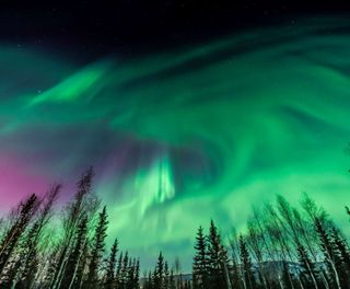 alaska northern lights green and pink colours istk