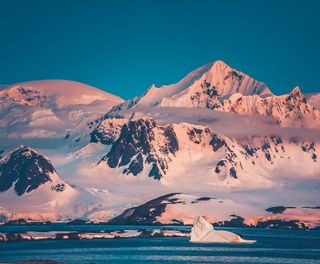 antarctica pink reflection on mountains istk