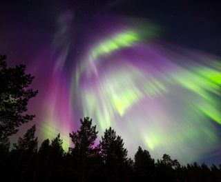 finnish lapland red and green northern lights nellim