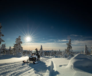 finnish-lapland-snowmobiling-winter-sun-whs