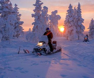 finnish lapland star arctic hotel snowmobile sunset