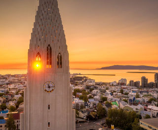 The midnight sun behind Hallgrimskirkja on the Reykjavik skyline, an impressive sight on an Iceland holiday