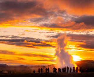 iceland south west strokkur geysir sunset people istk