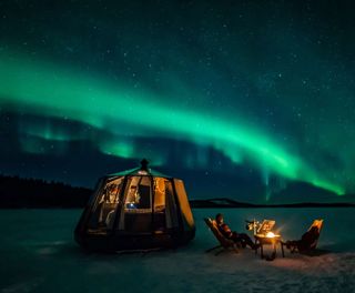 Nangu Wilderness Hotel aurora hut with northern lights above