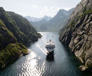 norway cruising through narrow fjord lofoten havila