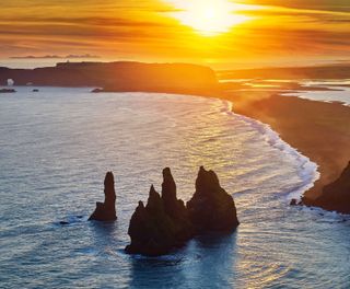 south coast iceland reynisdrangar rock stacks evening sun rth