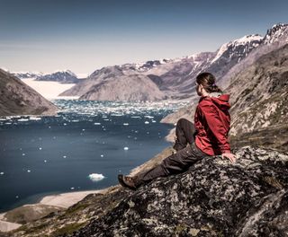 south greenland hiker overlooking qooroq ice fjord near narsarsuaq vg