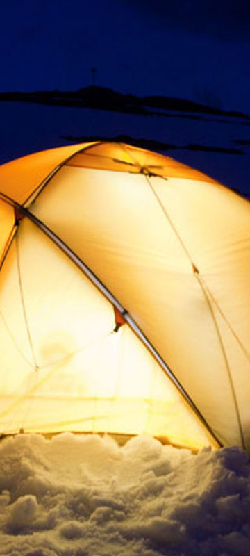 antarctic camping on ice tents lit up at night oc