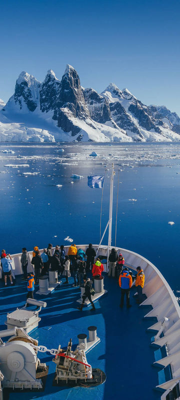 antarctic peninsula bow of ship cruising through tranquil channels qe