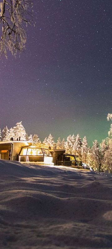 finnish lapland ranua arctic glass igloo row aurora sky