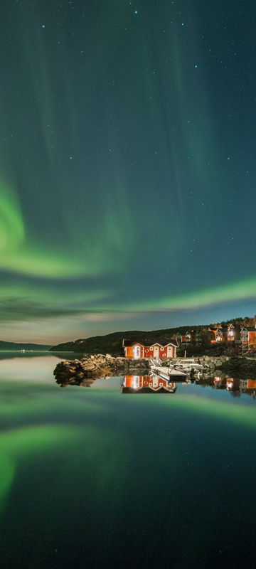 northern norway malangen resort aurora over fjord