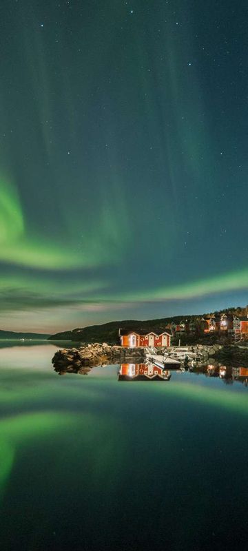 northern norway malangen resort aurora over fjord