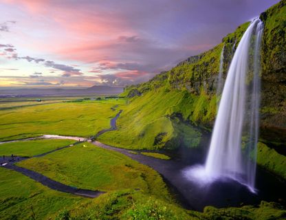 south west iceland seljalandsfoss pink sky robert lukeman unsplash