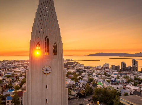 The midnight sun behind Hallgrimskirkja on the Reykjavik skyline, an impressive sight on an Iceland holiday