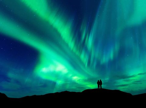 swedish lapland couple watching aurora borealis istk