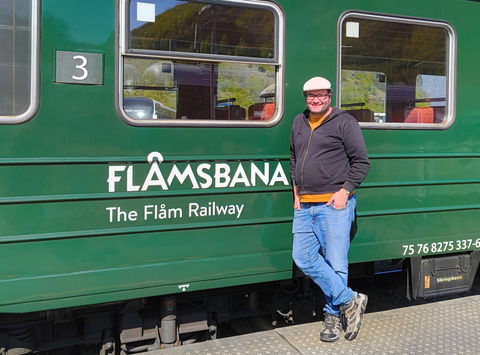 Travel Specialist Kieran standing beside the iconic Flamsbana in Norway