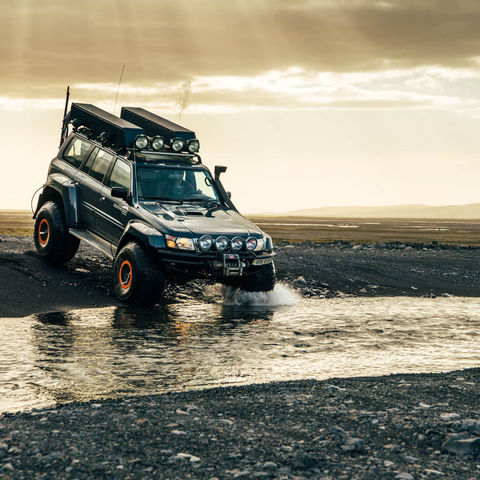 A superjeep crossing a river in Thorsmork, South Iceland - a classic Iceland experience