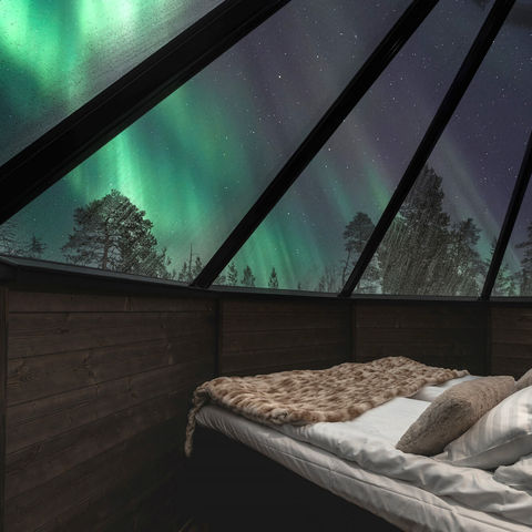 Gaze at the northern lights from an Aurora Cabin at Nellim Wilderness Hotel