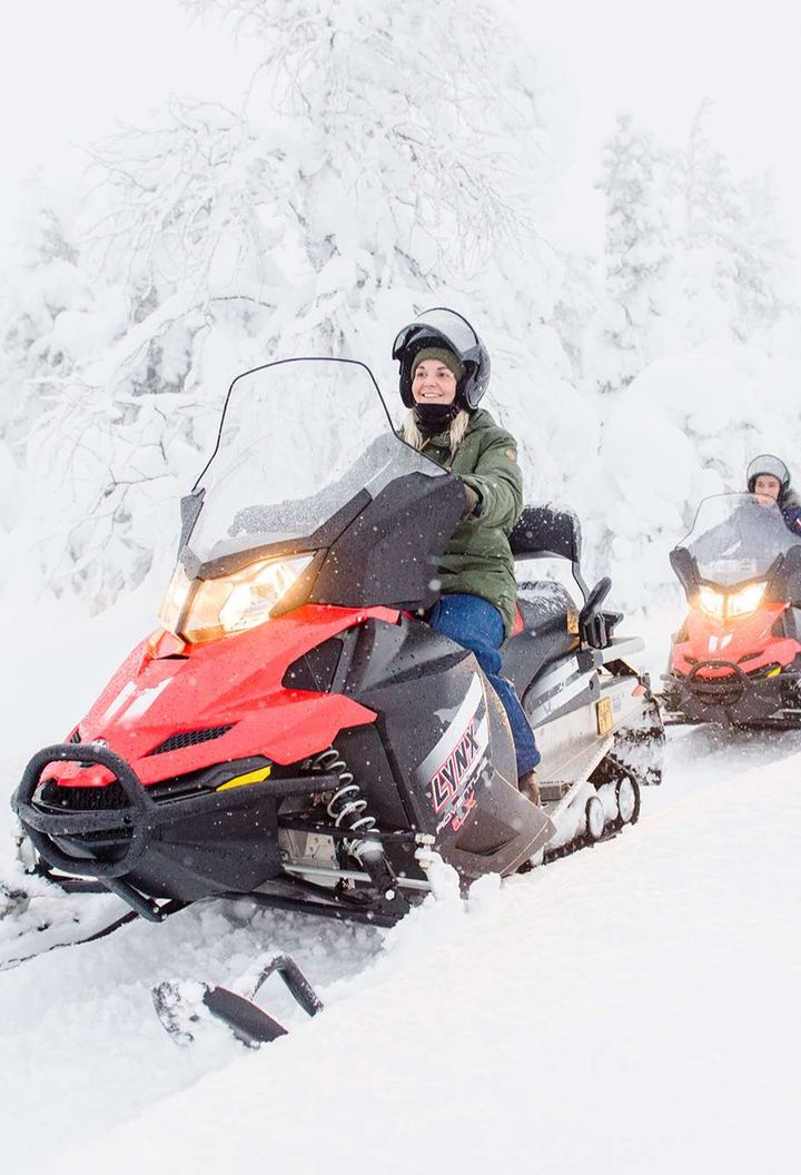 finnish lapland snowmobiling through snowy forest vf