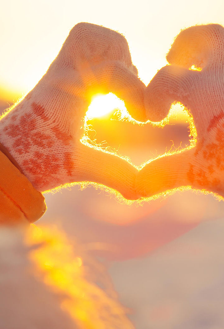 gloved hands forming heart shape istk