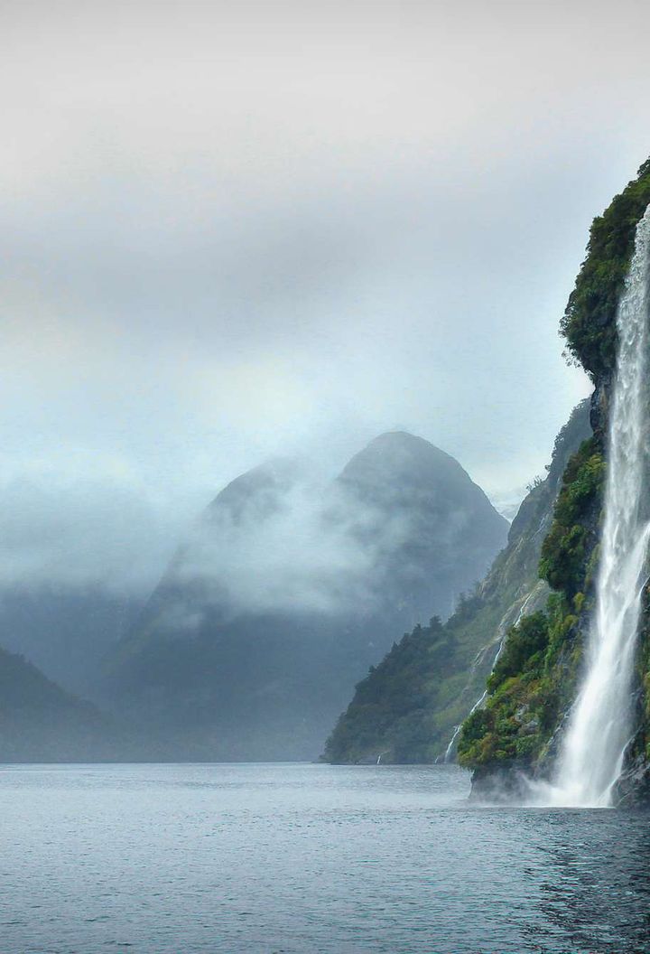 new zealand doubtful sound waterfalls cloudy day istk