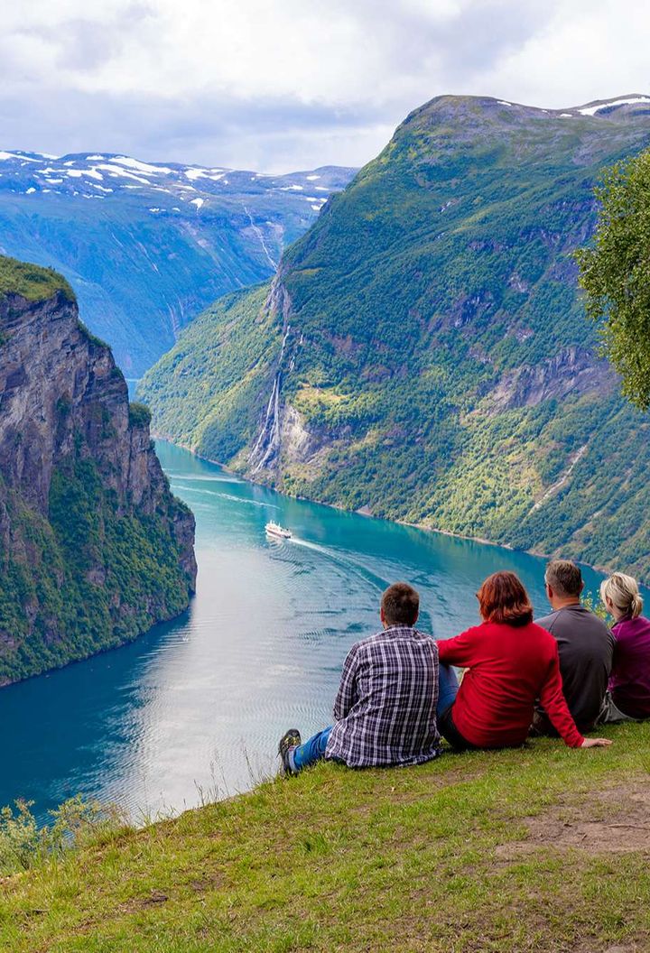 norway couples admiring geirangerfjord istk