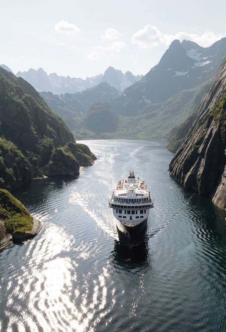 norway cruising through narrow fjord lofoten havila